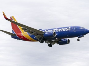 FILE - A Southwest Airlines flight prepares to land at Reagan National Airport, in Arlington, Va., Monday, Dec. 27, 2021. A Southwest Airlines flight attendant suffered a compression fracture to a vertebra in her upper back during a hard landing in July 2022 in California, according to federal safety investigators.