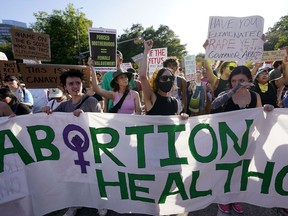 FILE - Demonstrators march and gather near the Texas state Capitol in Austin following the Supreme Court's decision to overturn Roe v. Wade on June 24, 2022. A federal judge in Texas issued a ruling on Tuesday, Aug. 23, 2022, temporarily blocking the federal government from enforcing guidance against the state that requires hospitals to provide abortion services if the life of the mother is at risk.