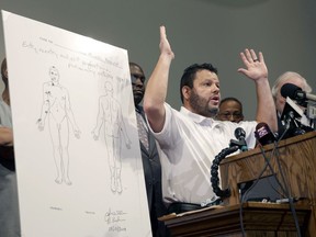 FILE - Shawn Parcells speaks during a news conference in St. Louis County, Mo., on Aug. 18, 2014. Parcells, a Kansas man convicted of performing illegal autopsies, has been permanently banned from doing business in the state and ordered to pay more than $700,000 in restitution and fines, Kansas Attorney General Derek Schmidt announced Wednesday, Aug. 10, 2022.