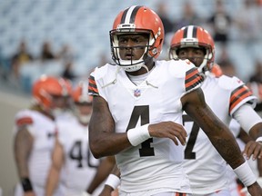 FILE - Cleveland Browns quarterback Deshaun Watson warms up before a preseason NFL football game against the Jacksonville Jaguars, Aug. 12, 2022, in Jacksonville, Fla. A person familiar with the situation tells The Associated Press on Thursday, Aug. 18, 2022, that Watson has reached a settlement with the NFL and will serve an 11-game suspension and pay a $5 million fine rather than risk missing his first season as quarterback of the Browns following accusations of sexual misconduct while he played for the Houston Texans.