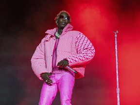 FILE - Young Thug performs on Day 4 of the Lollapalooza Music Festival on Aug. 1, 2021, at Grant Park in Chicago. The Atlanta rapper who's accused of conspiracy to violate Georgia's RICO Act and participation in a criminal street gang, is facing six new felony charges along with four others linked to the case. A new indictment was filed in Fulton County Superior Court last week against the artist, whose real name is Jeffery Williams.