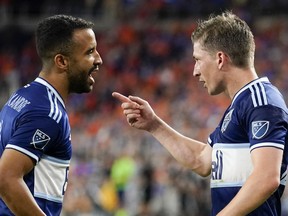 Vancouver Whitecaps' Ryan Gauld, right, speaks with midfielder Caio Alexandre during the second half of an MLS soccer match against FC Cincinnati on July 13, 2022, in Cincinnati. The Whitecaps have loaned Alexandre to Brazilian side Fortaleza EC through the end of the year.