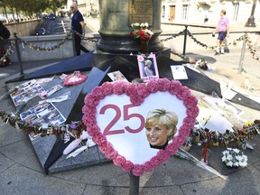 A poster sits by to the unofficial shrine to Princess Diana, Wednesday, Aug. 31, 2022 in Paris to mark the 25th anniversary of Princess Diana's death in a Paris car crash.