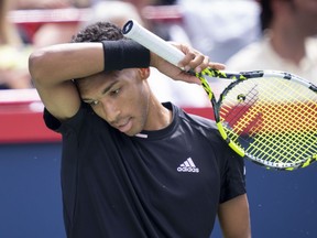 Felix Auger-Aliassime wipes his face during his match against Casper Ruud of Norway during quarterfinal play at the National Bank Open tennis tournament, Friday, August 12, 2022 in Montreal.