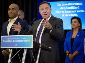 Quebec Premier François Legault, surrounded by CAQ candidates, speaks to the press in Laval, Que. on Aug. 12, 2022. In a video uploaded to social media, Legault says Quebec's fall provincial election campaign will begin Sunday, with the election scheduled for Oct. 3.