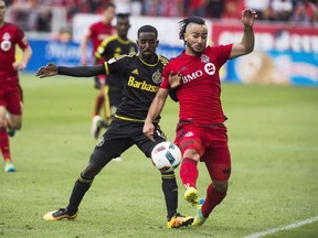Columbus Crew SC Mohammed Saeid gets tangled up with Toronto FC Mo Babouli second half MLS soccer action in Toronto Saturday May 21, 2016. York United FC of the Canadian Premier League has signed former Toronto and Forge FC forward Babouli through the end of 2024.THE CANADIAN PRESS/Aaron Vincent Elkaim