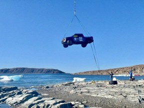 A helicopter airlifts a Ford F-150 into the air to transport it from near the Tasmania Islands to Gjoa Haven, Nvt., in a handout photo. An international team has completed the massive operation to recover the truck from remote Arctic waters. THE CANADIAN PRESS/HO-TransGlobal Car Expedition **MANDATORY CREDIT**