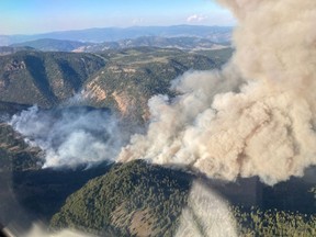 An aerial view of the Keremeos Creek wildfire is shown in a July 29, 2022 handout photo. Hot weather and dry conditions are the usual suspects in any wildfire season, but experts say a complex interplay of topography and unpredictable winds can create particularly challenging adversaries for firefighters. In British Columbia, shifting wind patterns have been a key concern for crews battling a fire in the South Okanagan which has forced the evacuation of hundreds of homes. Mary-Ann Jenkins, professor emeritus of atmospheric science at York University, Toronto, said fire generally moves in the same direction the wind is blowing. But mountains can complicate matters, she said. THE CANADIAN PRESS/HO-BC Wildfire Service **MANDATORY CREDIT**