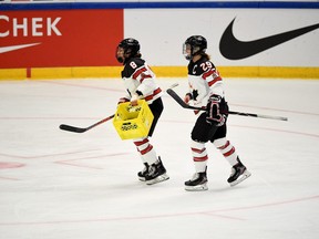 Laura Fortino (8) and Marie-Philip Poulin (9) of Canada warm up before the 2019 IIHF Women's World Championships preliminary match USA vs. Canada in Espoo, Finland on Saturday, 6th April, 2019. The Hamilton Bulldogs have tabbed Fortino as the Ontario Hockey League's first female assistant coach on Monday.THE CANADIAN PRESS /AP-LEHTIKUVA / ANTTI AIMO-KOIVISTO