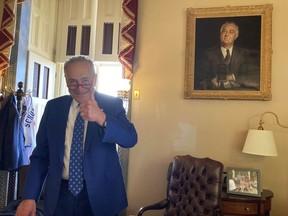 U.S. Sen. Chuck Schumer, D-N.Y., gives a thumbs-up in his office after the Senate approved Democrats' big election-year economic package, in Washington, Sunday, Aug. 7, 2022.