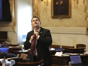 South Carolina Rep. Stewart Jones, R-Laurens, straightens his tie before a House session on a total ban on abortion on Tuesday, Aug. 30, 2022, in Columbia, S.C