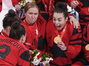 Team Canada's Brianne Jenner (19) and Sarah Nurse (20) celebrate with their gold medals after defeating the United States in women's hockey gold medal game action at the 2022 Winter Olympics in Beijing on Feb. 17, 2022. Nurse says the timing couldn't be better to be the first woman to grace the cover of EA Sports' NHL 23. The 27-year-old from Hamilton joined Anaheim Ducks centre Trevor Zegras as the faces of the video game's next edition unveiled Thursday.