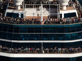 People stand on the decks at the bow of the Celebrity Cruises ship Celebrity Eclipse as it departs Vancouver Harbor for a voyage to Alaska, Sunday August 14, 2022.