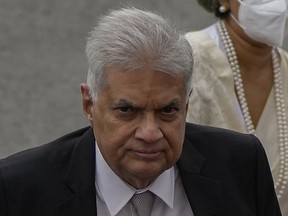 FILE - Sri Lankan president Ranil Wickremesinghe arrives at the parliamentary complex in Colombo, Sri Lanka on Aug. 3, 2022. Sri Lanka's new government plans Tuesday, Aug. 30, 2022 to present an amended budget for the year that slashes expenses and aims to provide relief to people hit hard by the country's economic meltdown.