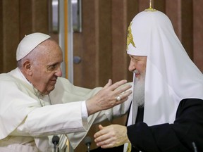 FILE - Pope Francis, left, reaches to embrace Russian Orthodox Patriarch Kirill after signing a joint declaration at the Jose Marti International airport in Havana, Cuba o Feb. 12, 2016. The head of the Russian Orthodox Church has canceled his planned attendance at an interfaith meeting in Kazakhstan in September where he was expected to meet with Pope Francis, a top Orthodox official said, in a sign of further deterioration in relations over Russia's war in Ukraine.