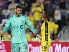 Nashville SC's Hany Mukhtar (10) celebrates after scoring a goal against Toronto FC goalkeeper Alex Bono (25) during the first half of an MLS soccer match Saturday, Aug. 6, 2022, in Nashville, Tenn.