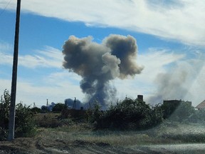 Smoke rises after explosions were heard from the direction of a Russian military airbase near Novofedorivka, Crimea Aug. 9.
