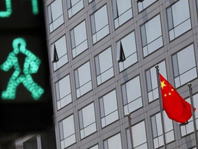 A Chinese national flag flutters outside the China Securities Regulatory Commission (CSRC) building on the Financial Street in Beijing, China