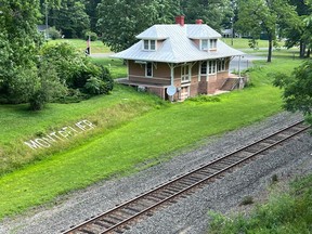 The Montpelier Station railroad depot, built in 1910 by William duPont, is seen from the entrance overpass into the James Madison's Montpelier historic site in Montpelier Station, Va. The United States Postal Service has closed the small Virginia post office over agency management's concerns about its location inside a historic train depot that also serves as a museum about racial segregation.