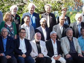 Quantum Gravity Conference keynote speakers pose for an official photo in Vancouver, on Wednesday, Aug. 17, 2022. The conference, which is being attended by two dozen of the world's top physicists including three Nobel Prize winners, is holding sessions on the beginning of the universe, the importance of quantum gravity, black holes and time travel. Seated in the front row from left to right are; Jim Peebles, Terry Hui, Kip Thorne, Frank Giustra, Philip Stamp and Markus Frind. Standing in the middle row from left to right; Suzanne Staggs, Paul Lee, Abhay Ashtekar, Moe Kermani and William Unruh. Standing in the back row from left to right are; Jordan Wilson-Gerow, Steven Carlip, Slava Mukhanov, Peter Galison, Renate Loll and Alex Vilenkin.