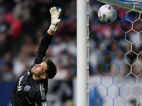 Vancouver Whitecaps goalkeeper Thomas Hasal allows a goal to Nashville FC's Jack Maher, not seen, during first half MLS soccer action in Vancouver on Saturday, August 27, 2022.