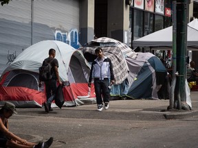 Tents line the sidewalk on East Hastings Street in the Downtown Eastside of Vancouver, where city workers started efforts to clear the encampment on Tuesday, August 9, 2022. The city's fire chief issued an order last month requiring the tents be cleared because of an extreme fire safety hazard.