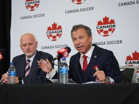 Canada Soccer president Nick Bontis, right, speaks as interim general secretary Earl Cochrane listens during a news conference, in Vancouver on Sunday, June 5, 2022.&ampnbsp;