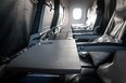 Airplane Seat Tray Open Empty Food Waiting. Inside the cabin of a Boeing. Seats in economy class.