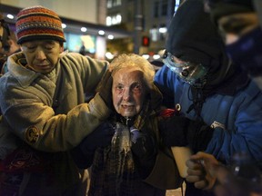 FILE - Seattle activist Dorli Rainey, 84, reacts after being hit with pepper spray during an Occupy Seattle protest on Nov. 15, 2011 at Westlake Park in Seattle. Rainey, who became a symbol of the Occupy protest movement after she was pepper-sprayed by Seattle police in 2011, has died on Aug. 12, 2022, at age 95. Her daughter, Gabriele Rainey, said her mom was "so active because she loved this country."