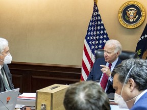 This photo provided and digitally altered by the White House shows President Joe Biden meeting with CIA Director William Burns, left, and other CIA and National Security advisers about al-Qaeda leaders and their locations, July 1, 2022, in the White House Situation Room.