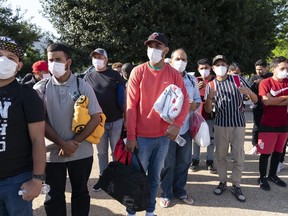 FILE - Migrants hold Red Cross blankets after arriving at Union Station near the U.S. Capitol from Texas on buses, April 27, 2022, in Washington. The Pentagon has rejected a request from the District of Columbia seeking National Guard assistance for the thousands of migrants being bused to the city from two southern states.