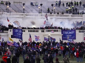 FILE - Violent insurrectionists loyal to President Donald Trump, storm the Capitol, Jan. 6, 2021, in Washington. A Maryland man described by the FBI as a "self-professed" white supremacist was sentenced on Wednesday, Aug. 10, 2022, to four months of incarceration for storming the U.S. Capitol while wearing a court-mandated device that tracked his movements, court records show. U.S. District Judge Timothy Kelly also sentenced Bryan Betancur to one year of supervised release after his term of imprisonment and ordered him to pay $500 in restitution.