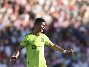 Manchester United's Cristiano Ronaldo reacts to his teammates during the English Premier League soccer match between Brentford and Manchester United at the Gtech Community Stadium in London, Saturday, Aug. 13, 2022.