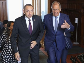 In this photo released by Russian Foreign Ministry Press Service, Serbia's Interior Minister Aleksandar Vulin, left, and Russia's Foreign Minister Sergei Lavrov walk during their meeting in Moscow, Russia, Monday, Aug. 22, 2022. (Russian Foreign Ministry Press Service via AP)