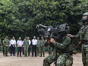 In this photo released by the Taiwan Ministry of National Defense, Taiwan's President Tsai Ing-wen watches soldiers operate equipment during a visit to a naval station on Penghu, an archipelago of several dozen islands off Taiwan's western coast on Tuesday, Aug. 30, 2022. Tsai told the self-ruled island's military units Tuesday to keep their cool in the face of daily warplane flights and warship maneuvers by rival China, saying that Taiwan will not allow Beijing to provoke a conflict. visit to the She also inspected a radar squadron, an air defense company, and a navy fleet.