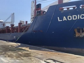 This frame grab from a video provided on Friday, July 29, 2022, shows A Syrian cargo ship Laodicea docked at a seaport, in Tripoli, north Lebanon. Lebanon appeared Friday to reject claims by the Ukrainian Embassy in Beirut that a Syrian ship docked in a Lebanese port is carrying Ukrainian grain stolen by Russia, following an inspection by Lebanese customs officials.  (AP Photo)