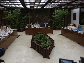 Colombia's Foreign Minister Alvaro Leyva, far left, Cuban Foreign Minister Bruno Rodriguez, top center, Colombian Peace Commissioner Danilo Rueda, second from left, and representatives from the United Nations meet with representatives of the Colombian guerrilla National Liberation Army (ELN) in Havana, Cuba, Friday, Aug. 12, 2022. The delegations of the Colombian government and the guerrilla National Liberation Army announced on Friday that they are committed to taking the necessary steps to try to reactivate the peace negotiations suspended four years ago.