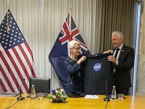 U.S. Deputy Secretary of State Wendy Sherman, left, hands New Zealand Economic and Regional Development Minister Stuart Nash a NASA t-shirt Tuesday, Aug. 9, 2022, during an agreement-signing event in Wellington, New Zealand. The United States is doubling down on its investment in the Pacific, said Sherman on Tuesday as she concluded a five-nation visit to the region.