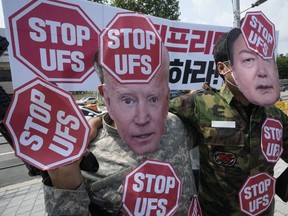 FILE - Protesters wearing masks of U.S. President Joe Biden, left, and South Korean President Yoon Suk Yeol stage a rally to oppose planned joint military exercises, called the Ulchi Freedom Shield, between South Korea and the United States on the occasion of U.S. House of Representatives Speaker Nancy Pelosi's visit in South Korea, in front of the presidential office in Seoul, South Korea Aug. 4, 2022. The United States and South Korea will begin their biggest combined military training in years next week in the face of an increasingly aggressive North Korea, which has been ramping up weapons tests and threats of nuclear conflict against Seoul and Washington, the South's military said Tuesday, Aug. 16, 2022. The banner reads "Stop the Ulchi Freedom Shield."