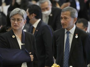 Australia's Foreign Minister Penny Wong, left, talks with Singapore Foreign Minister Vivian Balakrishnan during ASEAN - Australia Foreign minister Meeting in Phnom Penh, Cambodia, Thursday, Aug. 4, 2022.