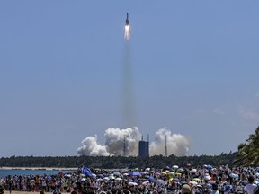 FILE - In this photo released by Xinhua News Agency, people gather at the beach side as they watch the Long March 5B Y3 carrier rocket, carrying Wentian lab module, lift off from the Wenchang Space Launch Center in Wenchang in southern China's Hainan Province Sunday, July 24, 2022. There was no reported damage in a western Philippine region, where debris from a rocket that boosted part of China's new space station reportedly fell, a Filipino official said Monday, Aug. 1.
