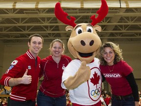 Canadian Olympians Jason Burnett, left to right, Sami Jo Small, Olympic team mascot Komak and Olympian Cheryl Pounder pose for a photograph after being introduced to students at St. Lawrence Catholic Elementary School in Hamilton, Ont., Friday, December 6, 2013. Former Canadian women's hockey team goalie Sami Jo Small has been appointed president of the Premier Hockey Federation's Toronto Six.