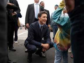 Prime Minister Justin Trudeau greets a young girl in a crowd following an announcement during the Liberal summer caucus retreat in St. Andrews, N.B., Tuesday, Sept. 13, 2022. THE CANADIAN PRESS/Darren Calabrese