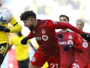 Toronto FC midfielder Jonathan Osorio heads the ball during the second half of an MLS soccer match against the Columbus Crew, in Columbus, Ohio, Saturday, March 12, 2022.&ampnbsp;While called up by Canada coach John Herdman, a Toronto FC spokeswoman says Osorio remained in Toronto "to continue his recovery process."