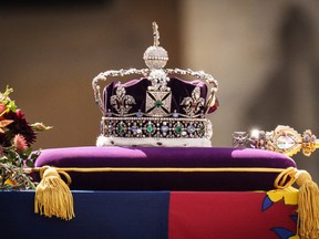 The coffin of Queen Elizabeth II with the Imperial State Crown resting on top, borne on the State Gun Carriage of the Royal Navy departs Westminster Abbey on September 19, 2022 in London, England.
