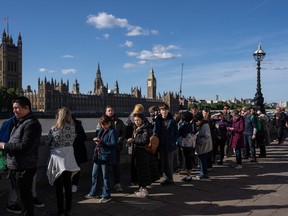 People queue opposite the Palace of Westminster as they wait to pay their respects to Queen Elizabeth II as she lies in state in Westminster Hall on September 17, 2022 in London, United Kingdom. (Photo by Carl Court/Getty Images)