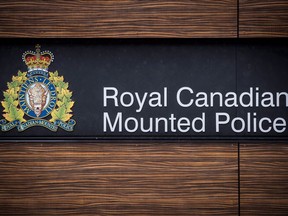 The RCMP logo is seen outside Royal Canadian Mounted Police "E" Division Headquarters, in Surrey, B.C., on Friday April 13, 2018.&ampnbsp;Police say a man is seriously injured after being run over by a truck near a homeless encampment in Kelowna, B.C.