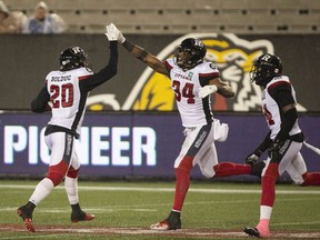 Ottawa Redblacks Kyries Hebert (34) celebrates with teammate Jean-Philippe Bolduc (20) after making an interception during second half CFL Football game action against the Hamilton Tiger-Cats in Hamilton, Ont. on Saturday, October 27, 2018.