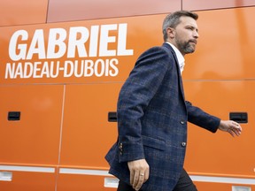 Québec solidaire spokesman Gabriel Nadeau-Dubois walks back to the campaign bus following a campaign stop in Gatineau, Que., Tuesday, Sept. 6, 2022.