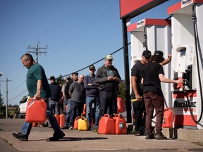 Local residents wait in line to fill up gas cans a day after Post-Tropical Storm Fiona hit the Atlantic coast n September 25, 2022 in New London, Prince Edward Island, Canada. It’s estimated that 80,000 residents on Prince Edward Island remained without power. Formerly, Hurricane Fiona, the downgraded storm is one of the strongest Canada’s Atlantic coast has seen in years.